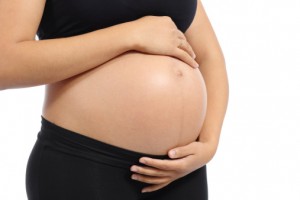 pregnant woman cradles belly