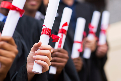 graduates with diplomas