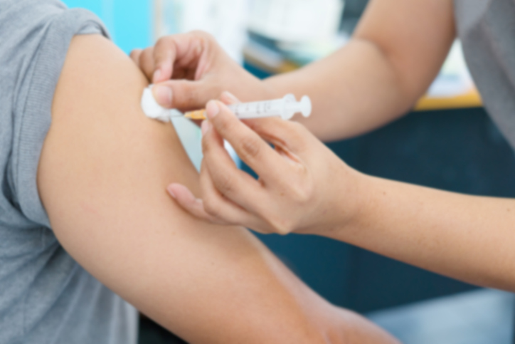 Blurry Background of Nurse are vaccinations to patient. To prevent diseases that are prevalent. closed-up of hand with vaccine shot.